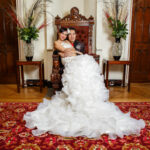 newlyweds embrace on the throne in the reception area of the castle