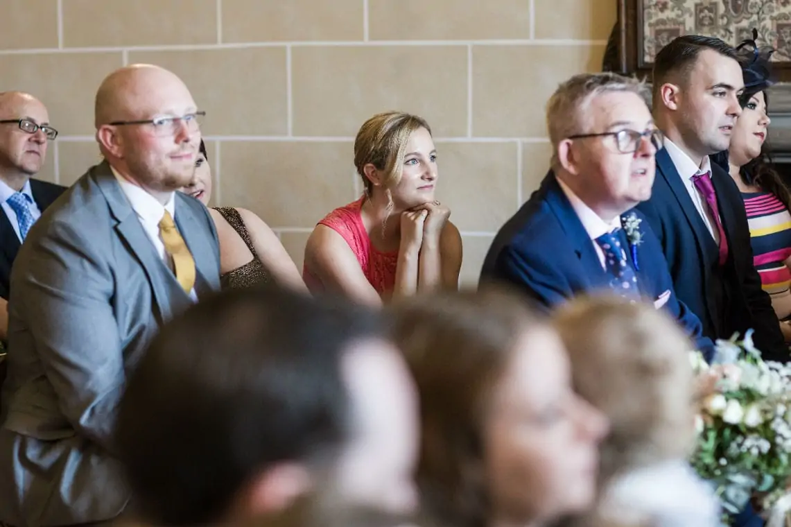 Guests watching bride and groom getting married in the Chapel.