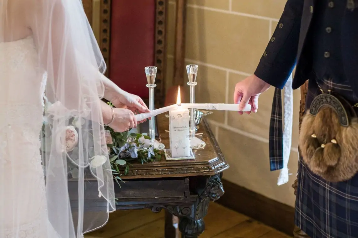 Bride and Groom lighting a candle.