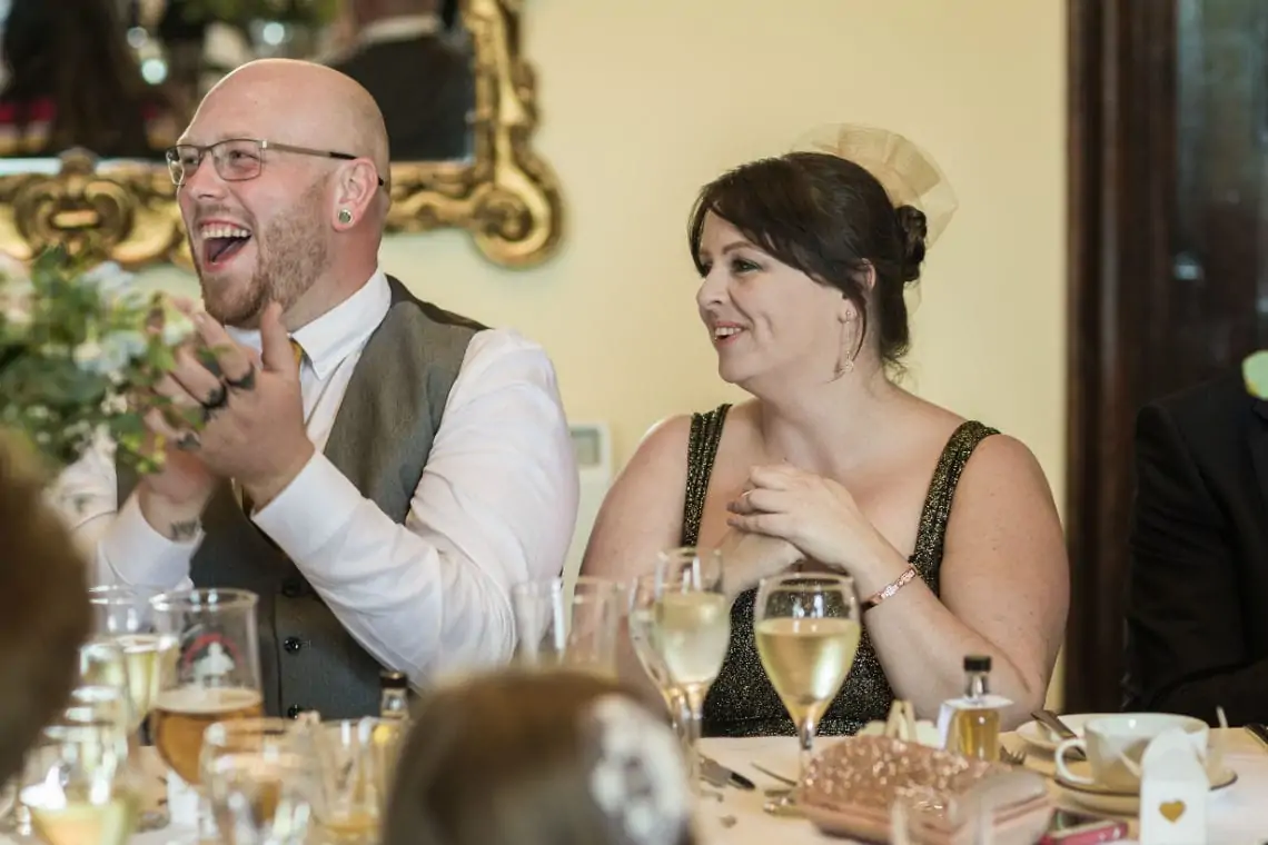 Guests laughing at speeches.
