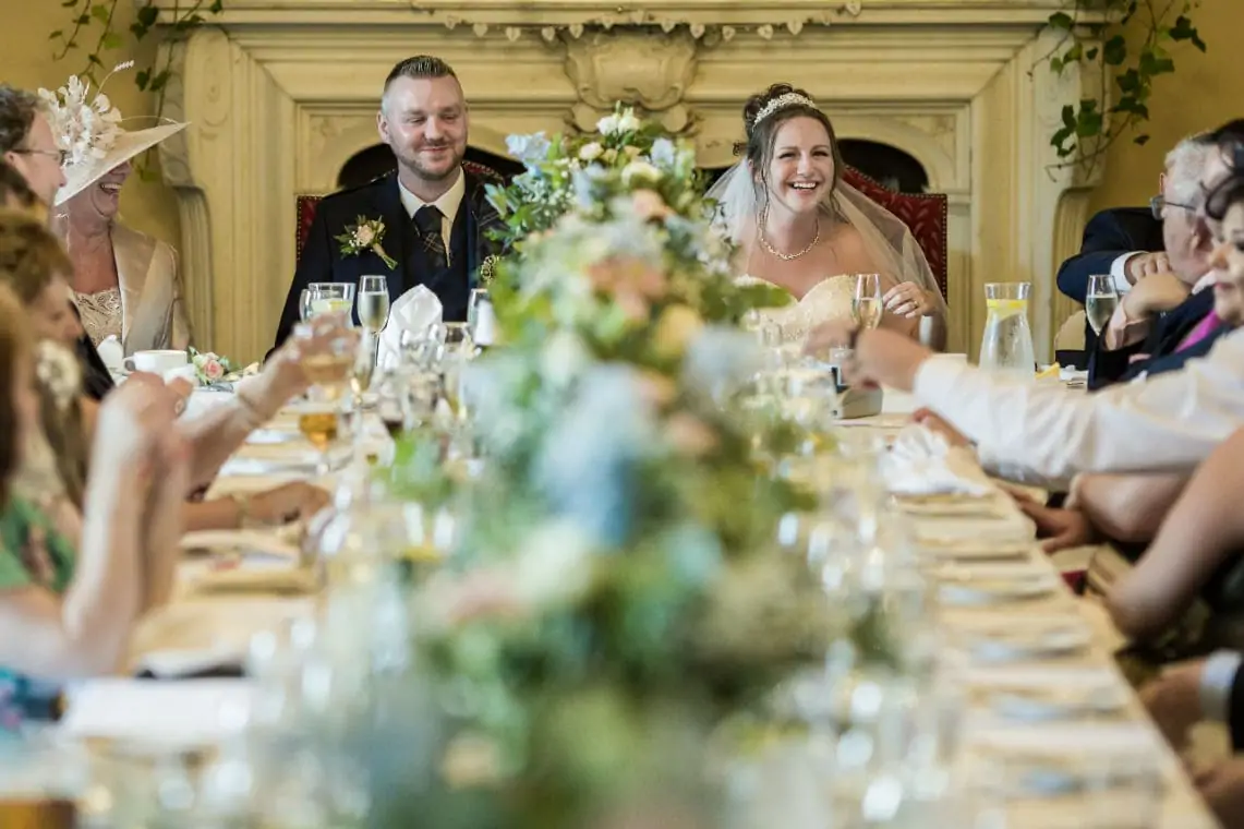 Bride and Groom sitting at the top table during speeches in The Ramsay Suite.