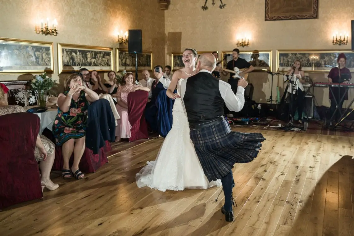 Bride with Dad dancing together in The Sir Alexander Suite of the castle.