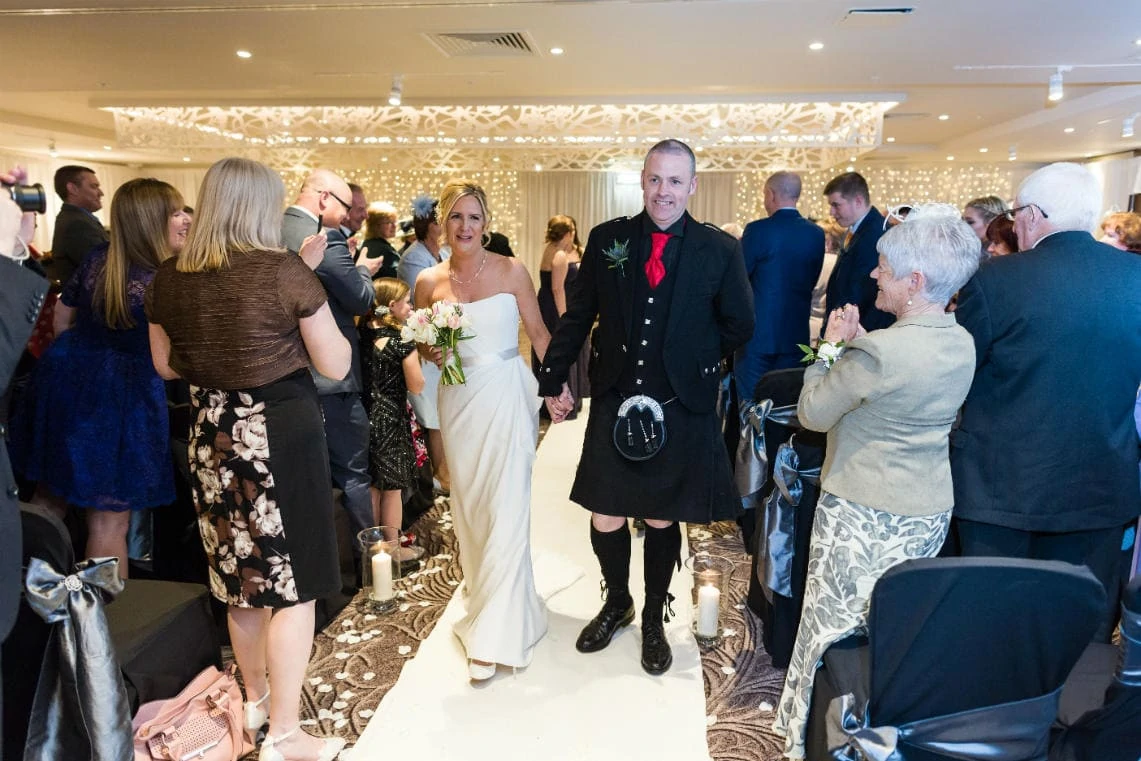 Dalmahoy Suite - recessional bride and groom walking up the aisle