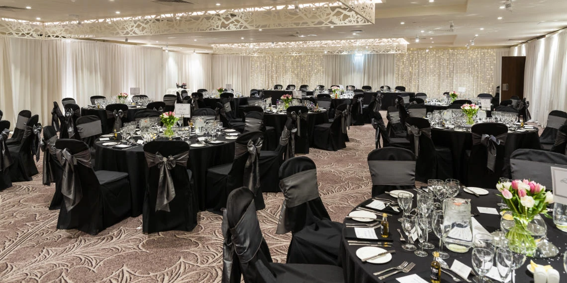 Dalmahoy Suite - wide angle set up for meal with black table and chair covers
