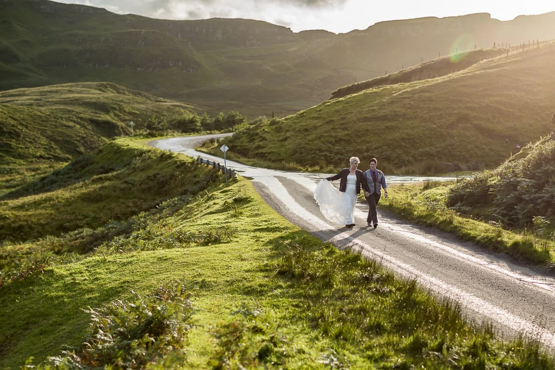 newly-wed lesbian couple walking on a road Quiraing