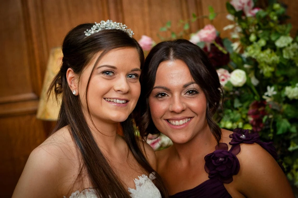 bride and bridesmaid smiling in the Main Hall