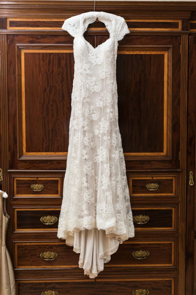 bride's dress hanging from a wardrobe in the Winter bedroom