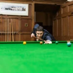 groom playing snooker in the Billiards Room
