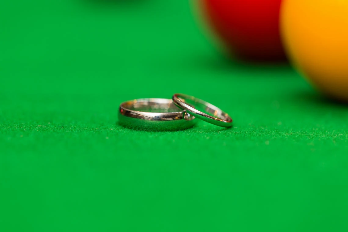 bride and groom's rings on the snooker table