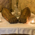 knight's armoured gloves on display on a table in the hallway of the Auld Keep