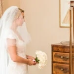 bride holding her bouquet of flowers in the Winter bedroom