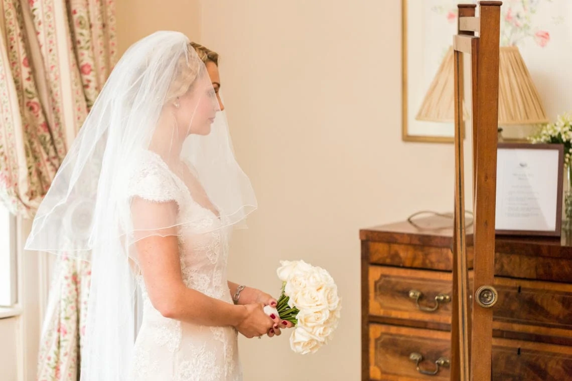bride holding her bouquet of flowers in the Winter bedroom