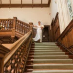 bride makes her way down the staircase into the Main Hall