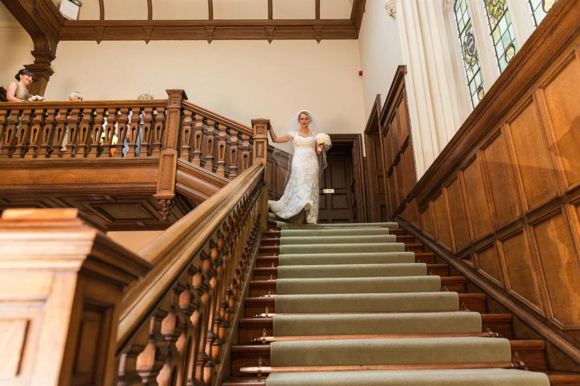 bride makes her way down the staircase into the Main Hall