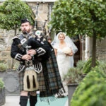 bride is led by the piper to the Auld Keep