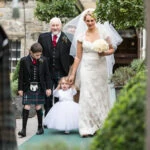 bride, her father, daughter and nephew are led by the piper to the Auld Keep