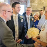 bride and groom smiling at each other in the Auld Keep