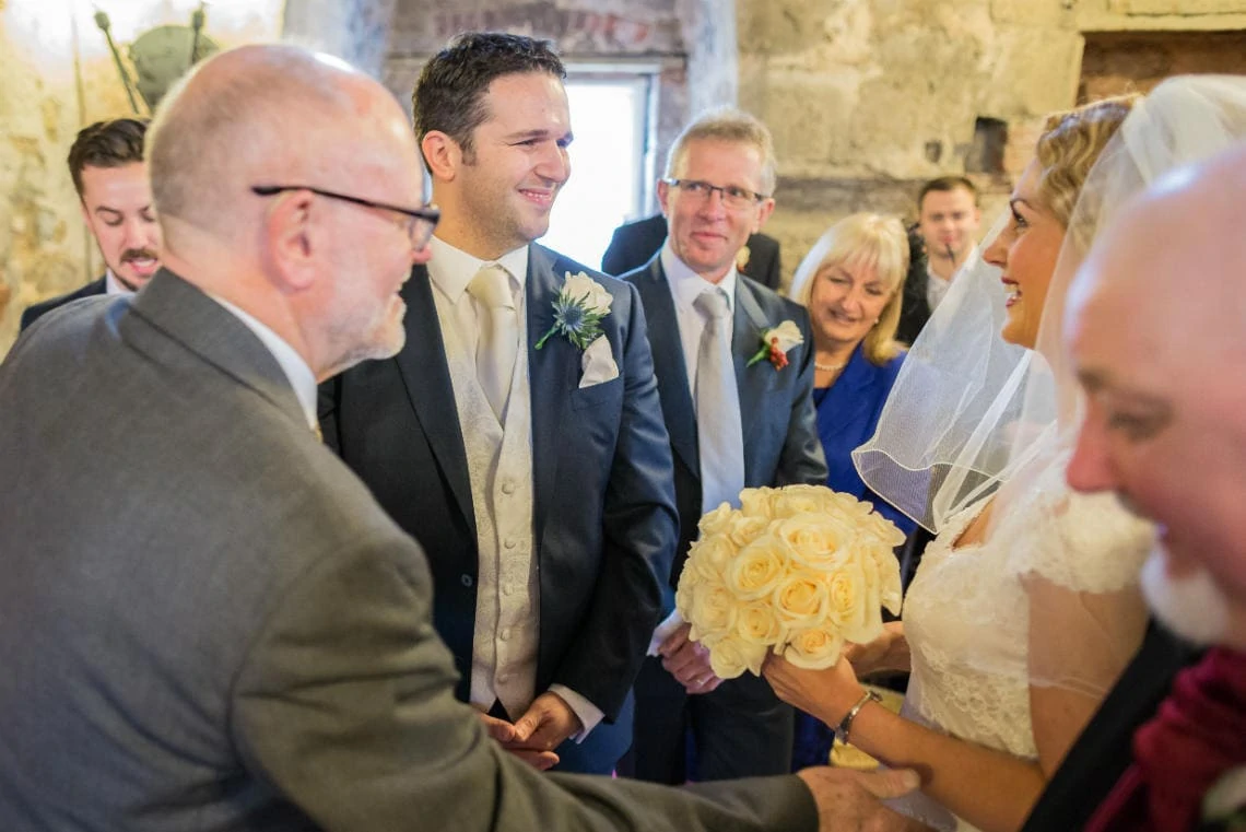 bride and groom smiling at each other in the Auld Keep