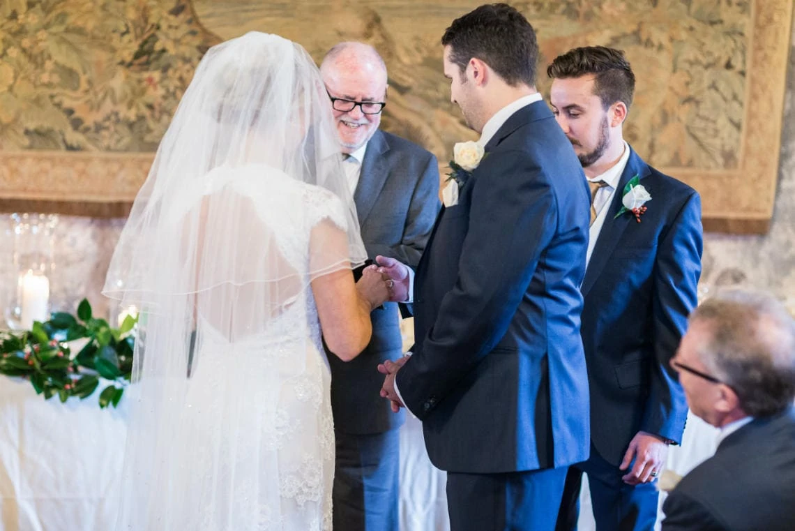 best man hands over a ring to the bride during Humanist ceremony in the Auld Keep