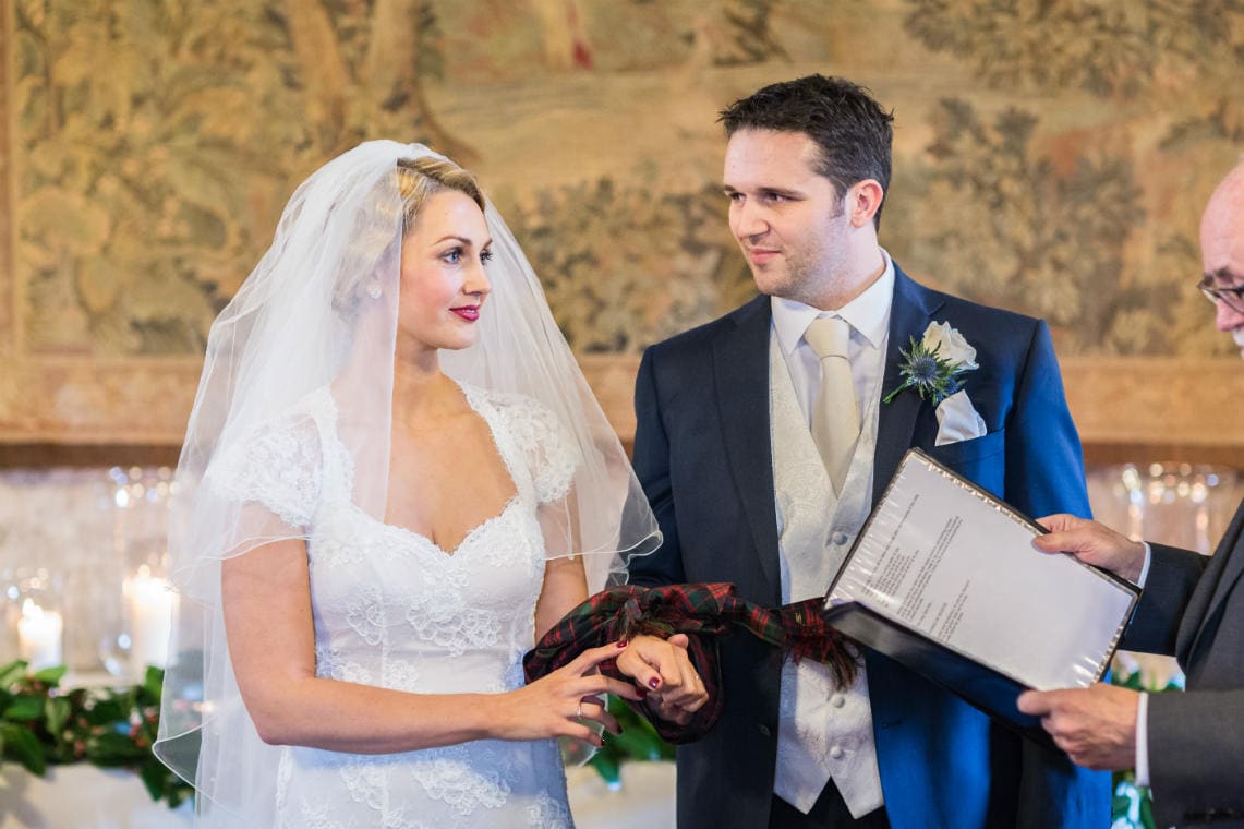 bride and groom literally 'tie the knot' in the Auld Keep