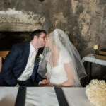 newlyweds kiss after signing the marriage schedule in the Auld Keep annex
