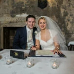 newlyweds signing the marriage schedule in the Auld Keep annex