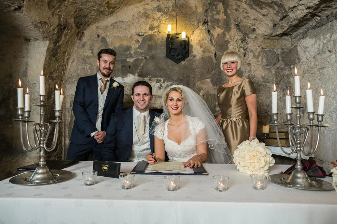 newlyweds, best man and maid of honour after signing the marriage schedule in the Auld Keep annex
