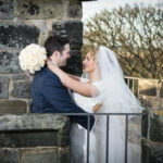 newlyweds embrace on the roof of the Auld Keep