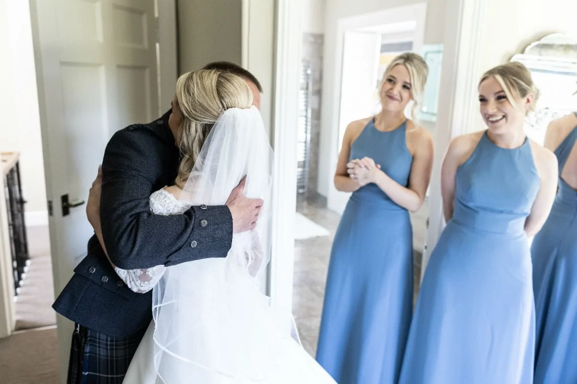 father hugs his daughter bride