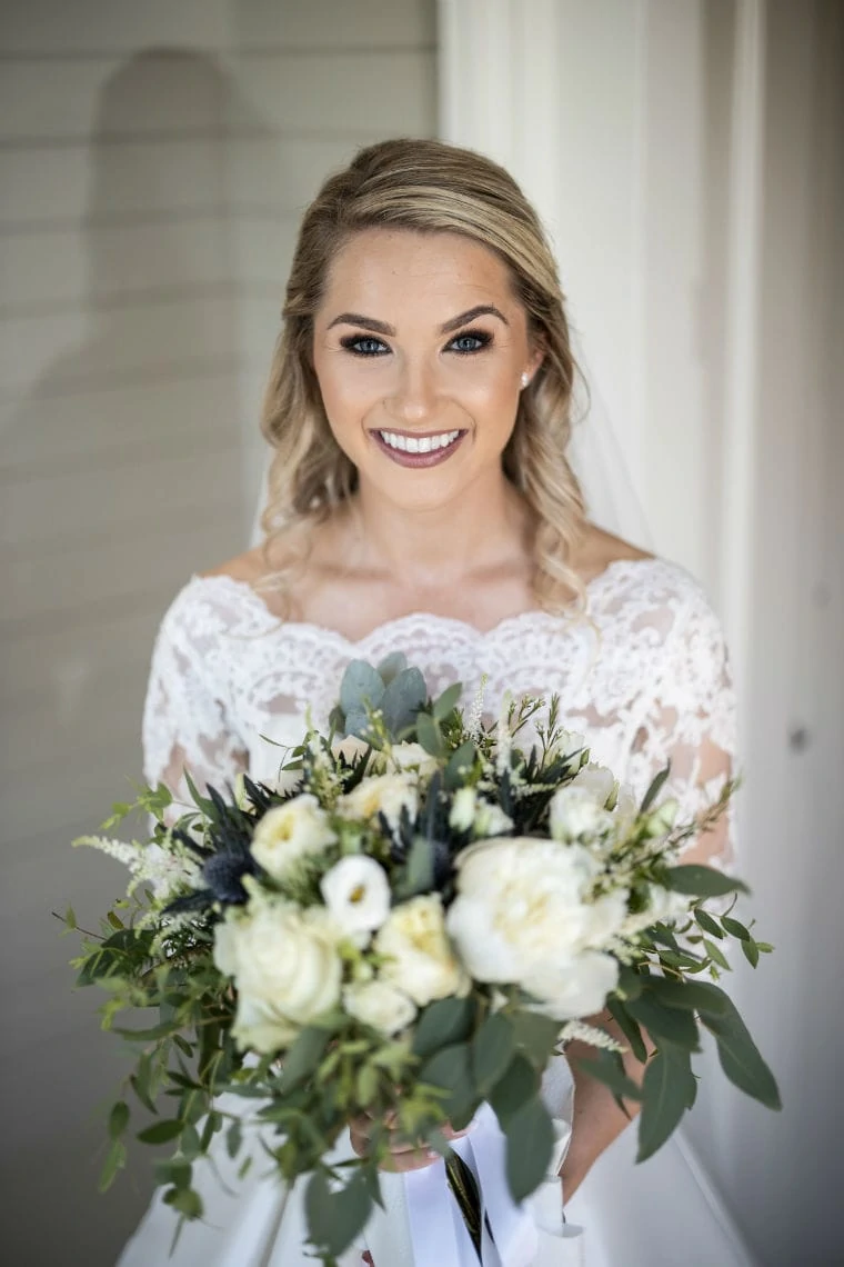 bride poses with her bouquet