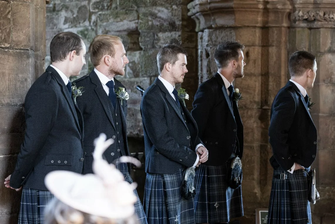 groom and groomsmen wait for the arrival of the bride
