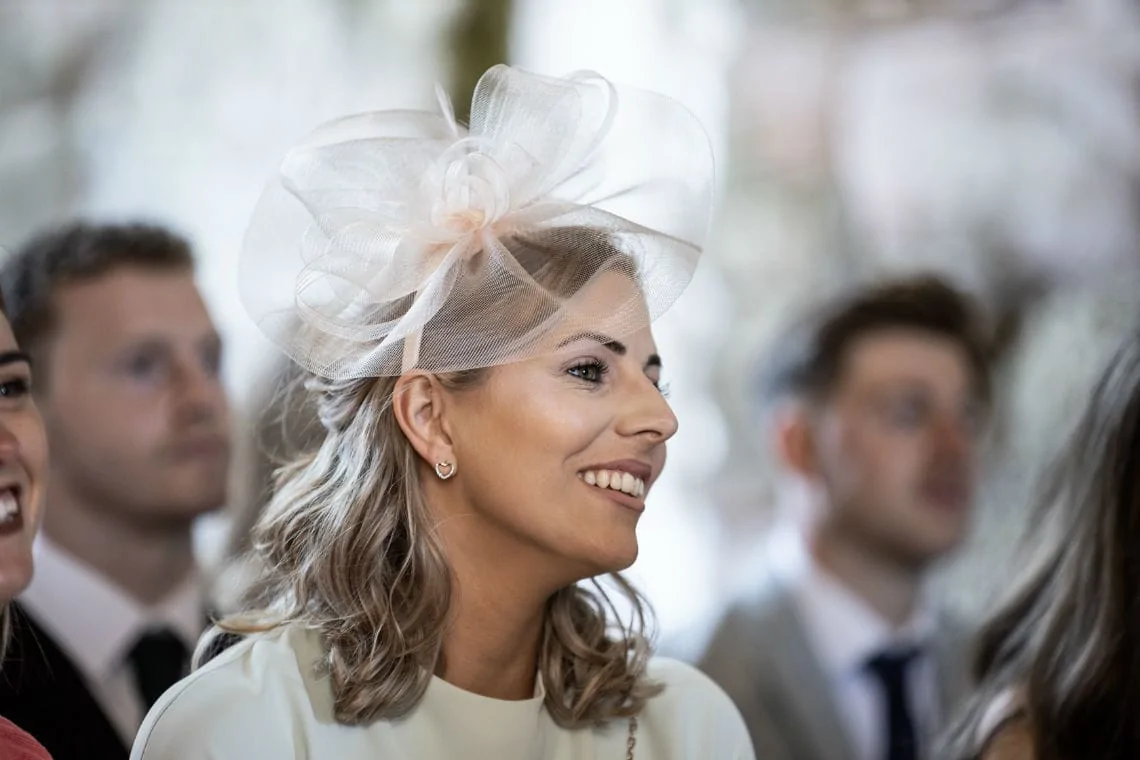 female guest smiling during ceremony