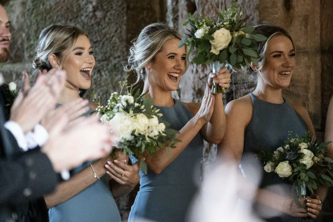 bridesmaids cheering the newlyweds in the church
