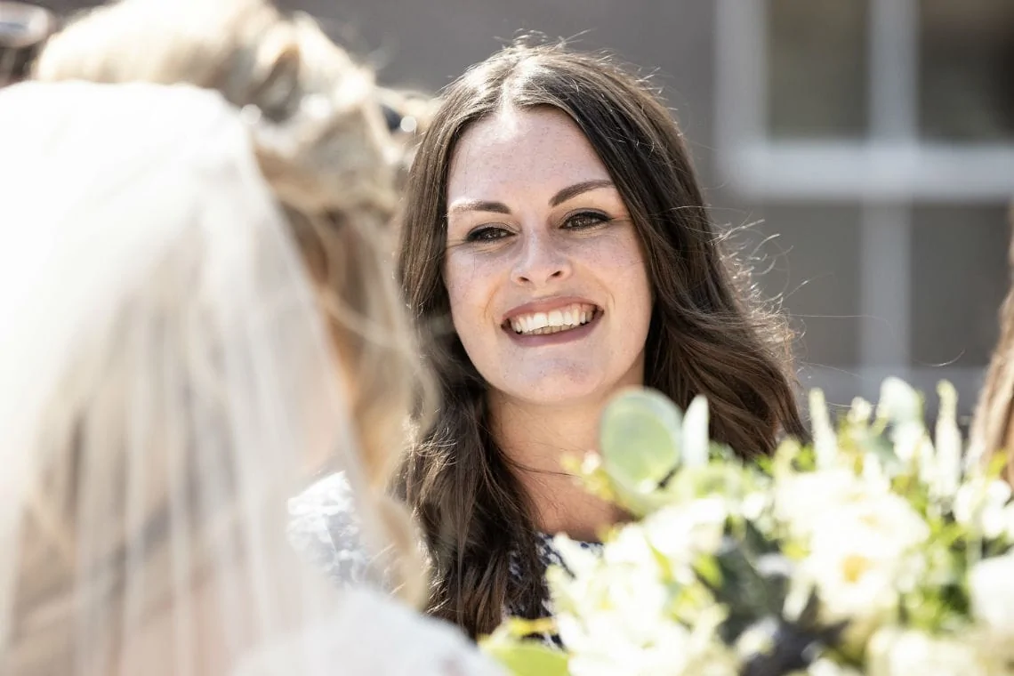 female guest smiling at the bride
