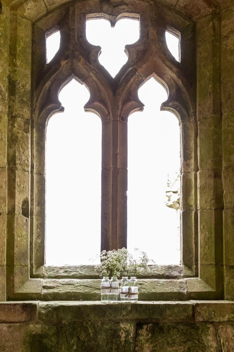 flowers on the ledge of the window of the church