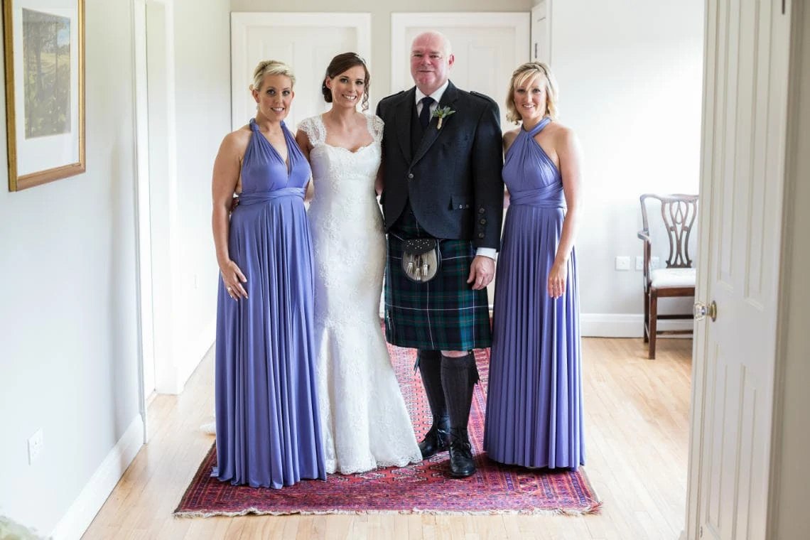 bride, her father and bridesmaids a few minutes before they depart for the church