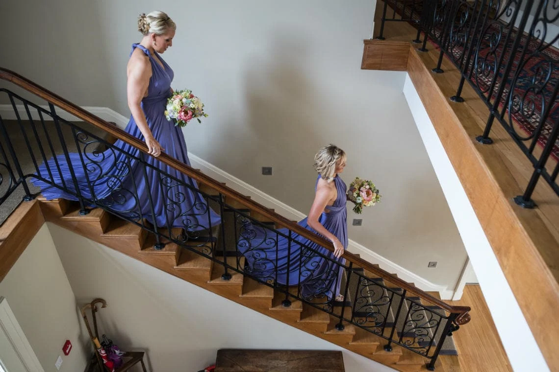 bridesmaids walking down the stairs of Dunglass House
