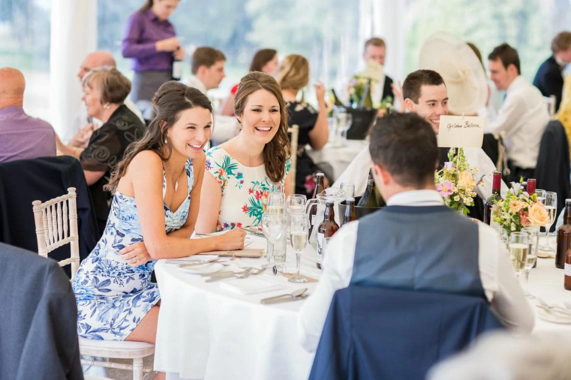 guests chatting at their table in the marquee