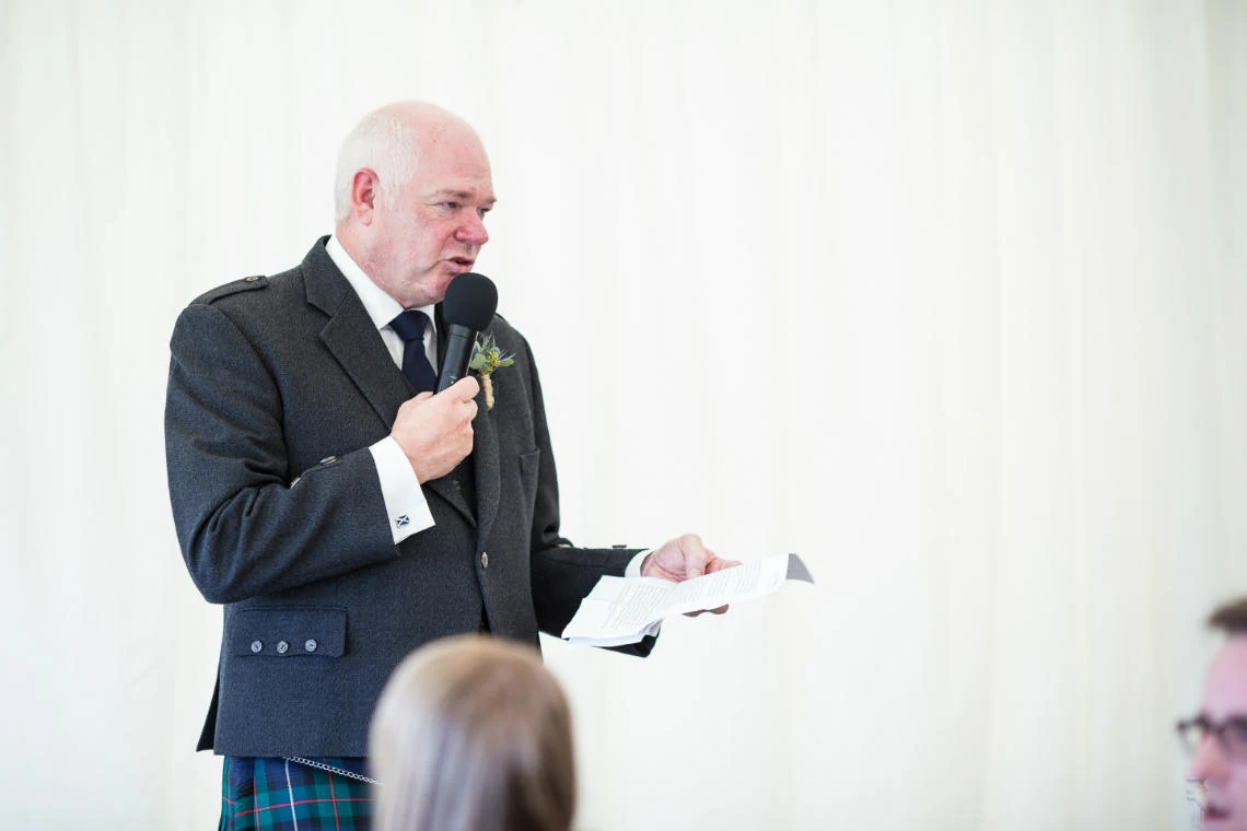 father of the bride delivers his speech in the marquee