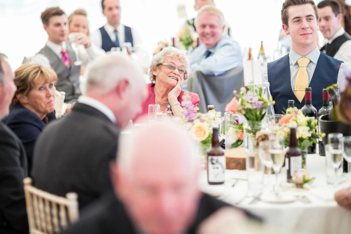 granny listens and smiles during the best man speech