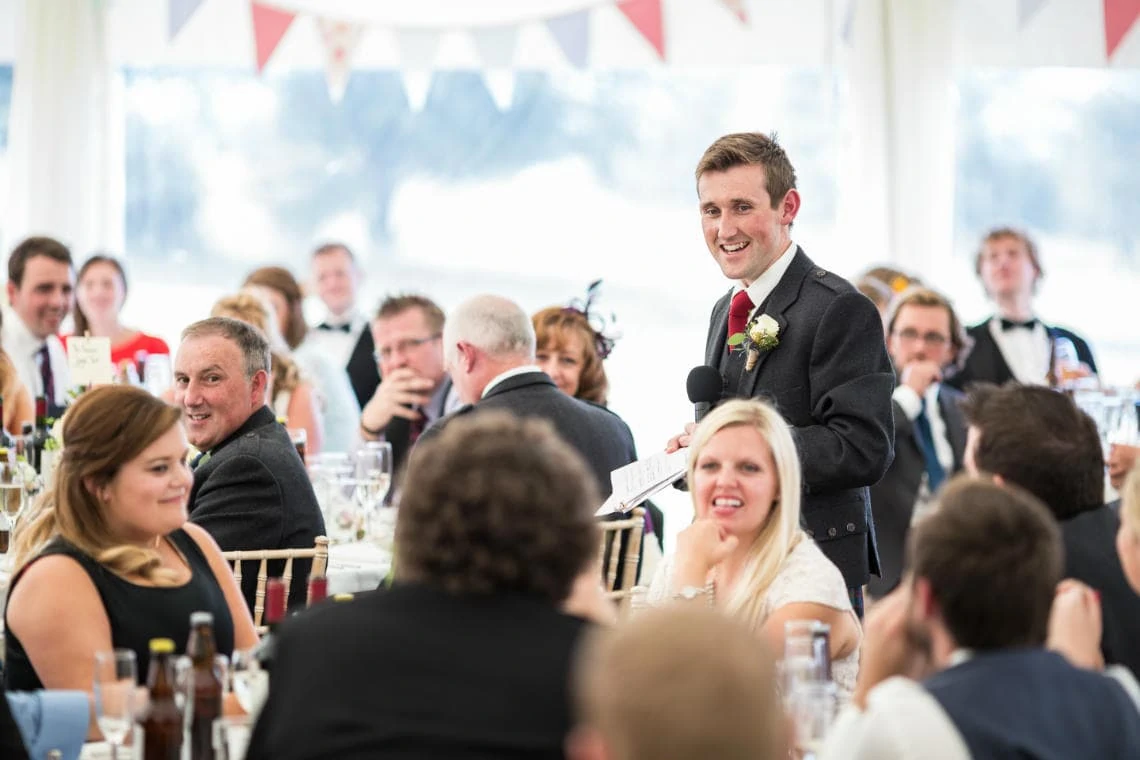 groom during his speech as guests watch