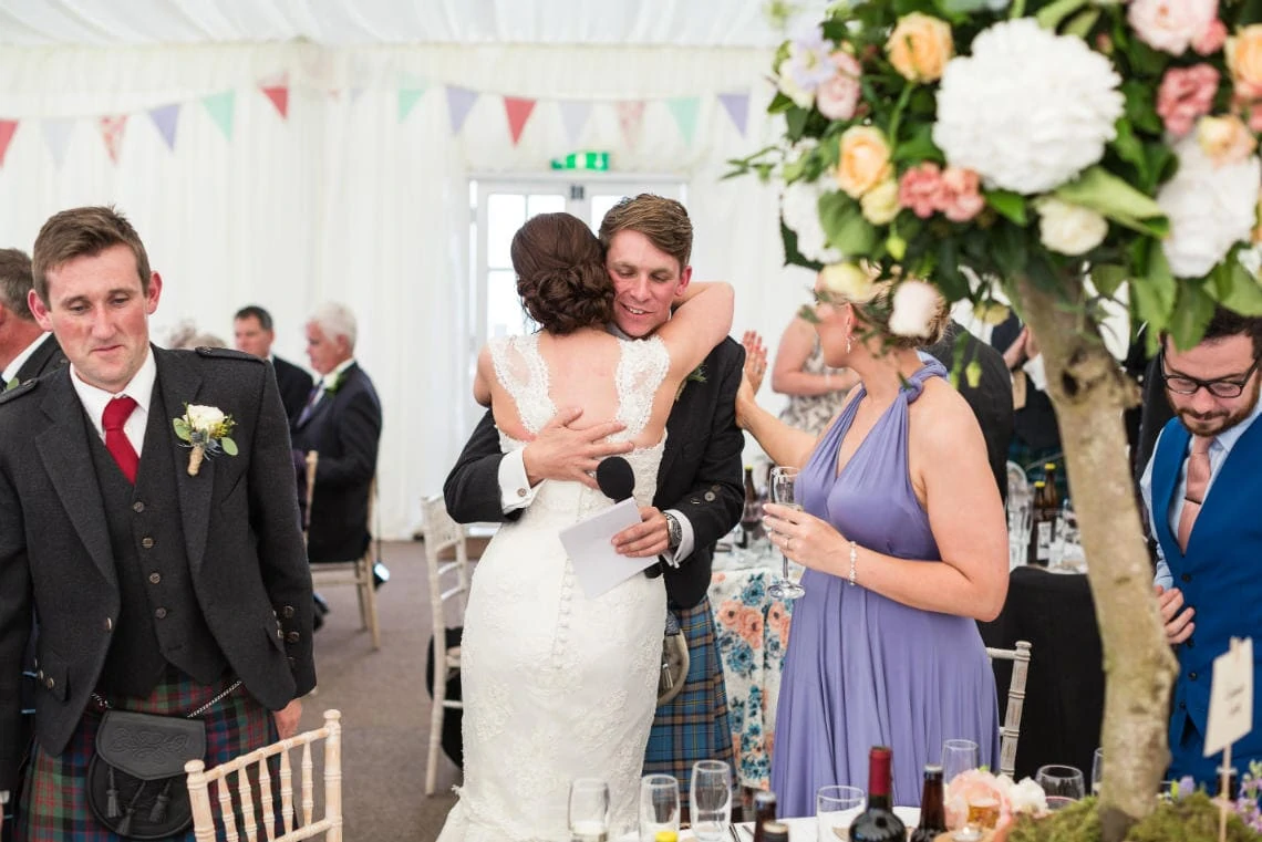 bride hugs the best man at the end of his speech
