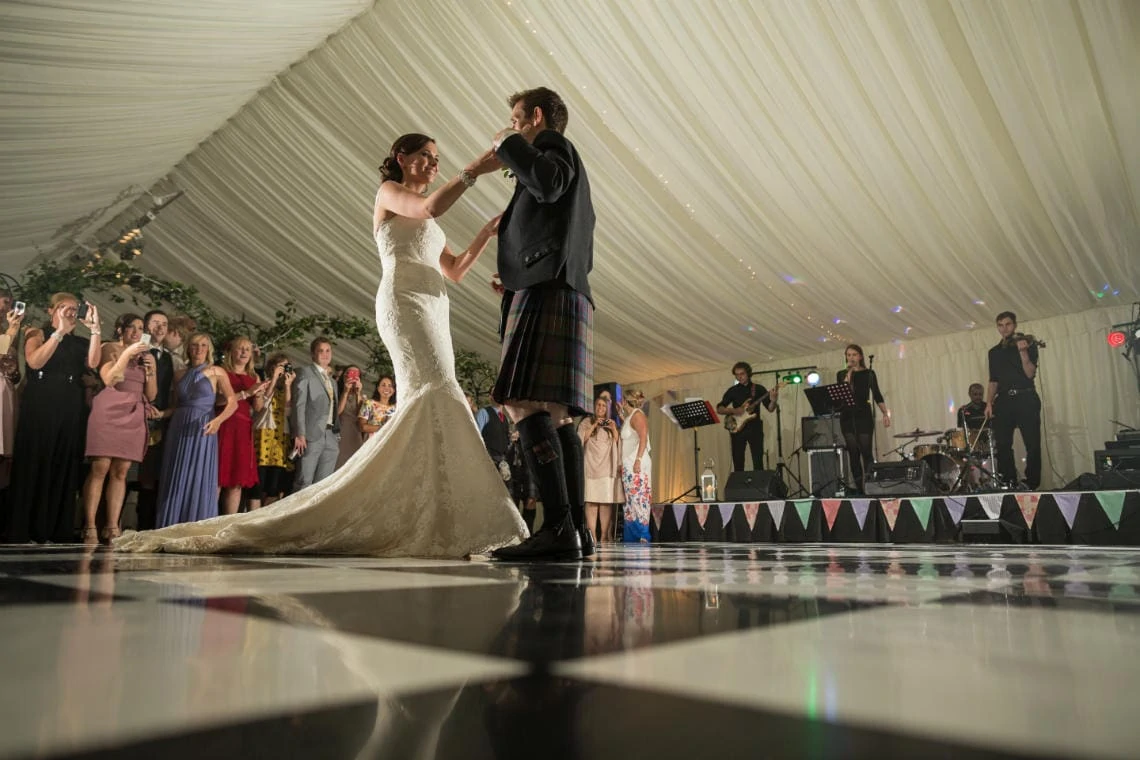 newlyweds ' first dance in the marquee with Callanish playing live in the background