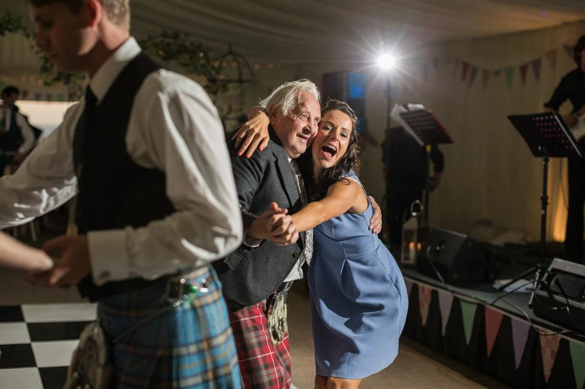 a female guest dances with an elderly male guest