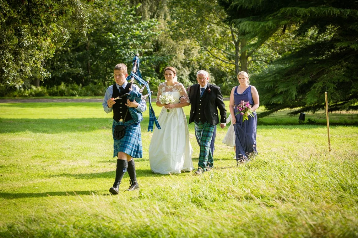 bridal party led by the piper to Dunglass Church