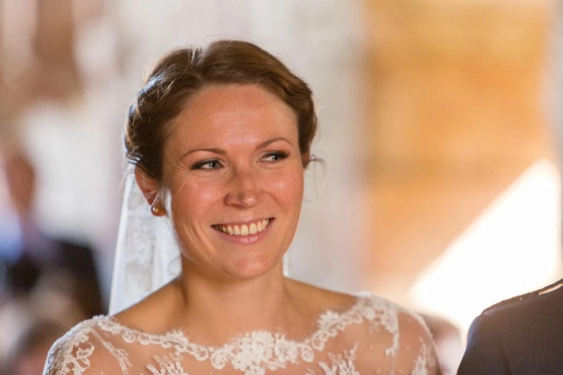 smiling bride as she walks up the aisle