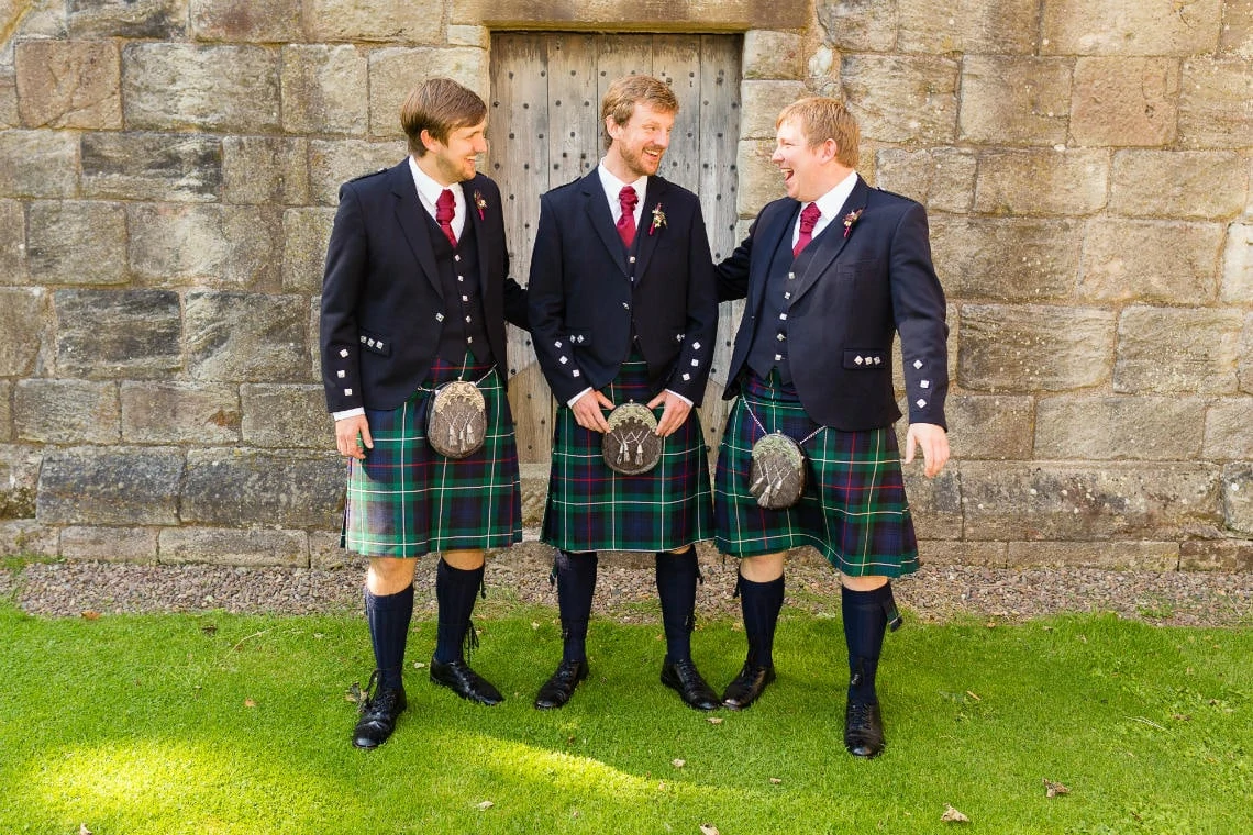 groom and best men in front of Dunglass Church