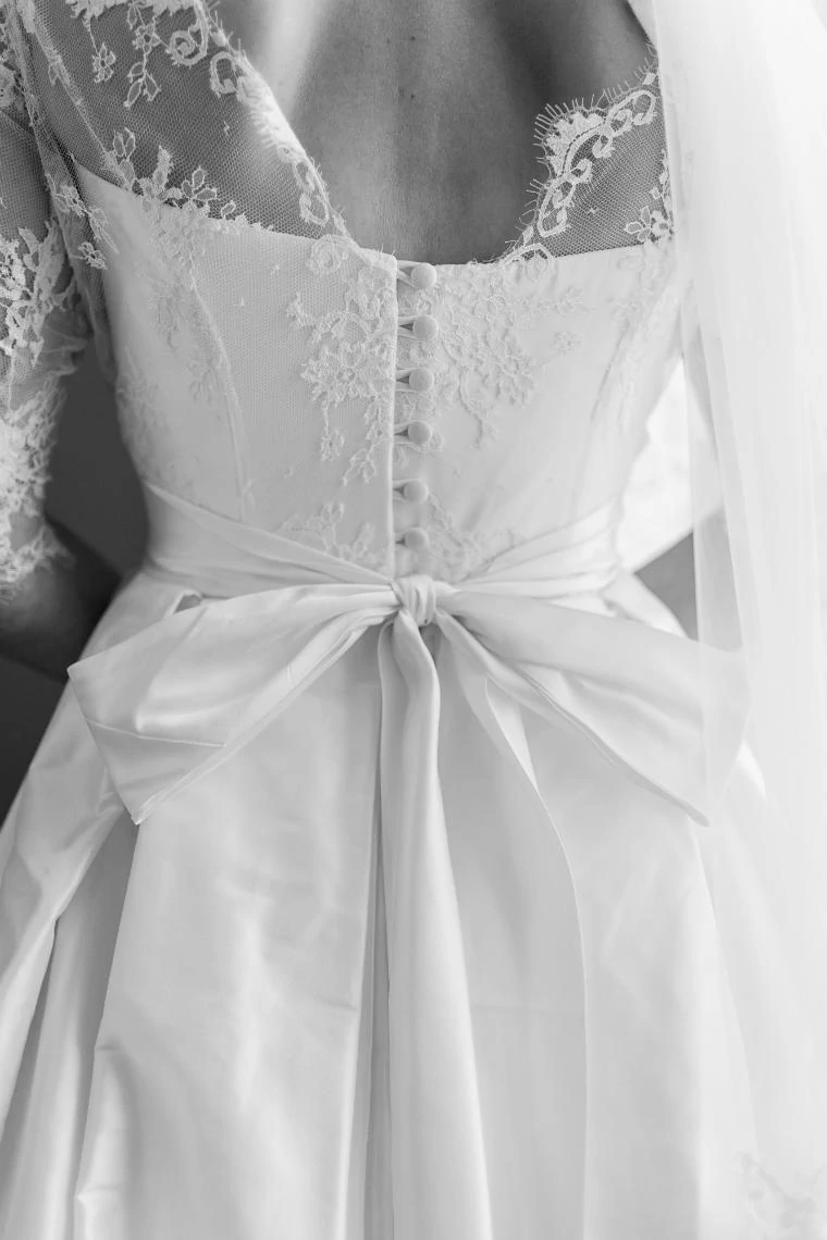 back of bride's white dress showing bow and button details