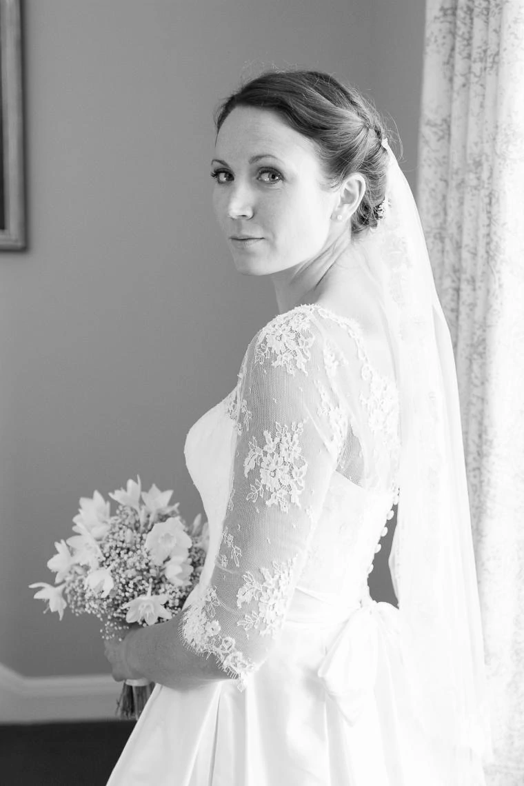 bridal portrait looking over her shoulder on the staircase of Dunglass House