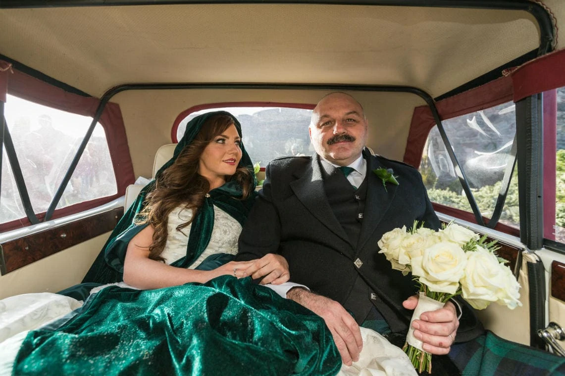 bride and father inside their wedding car